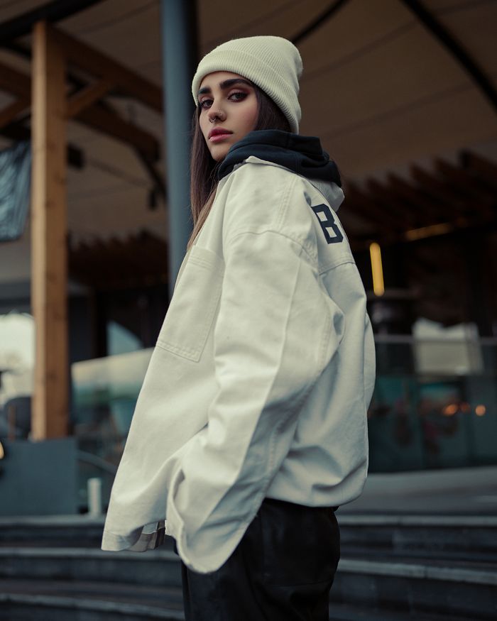 Portrait of a young woman in a casual street style outfit, outdoors.